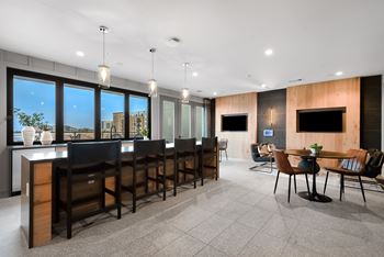 Sports lounge with tvs, kitchen & accordion window for indoor/outdoor experience